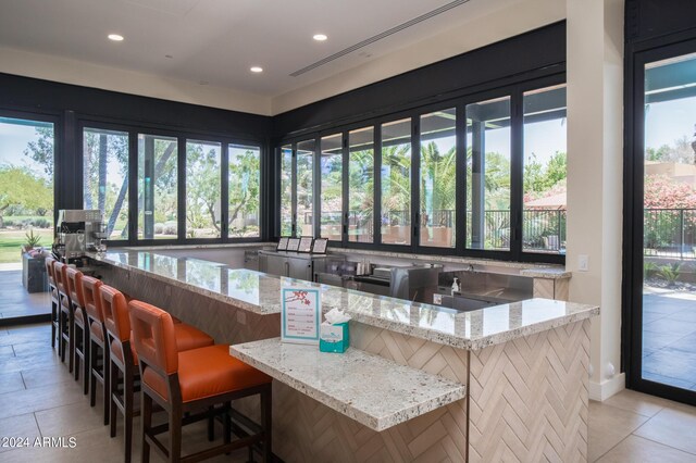 dining area featuring light wood-type flooring and a drop ceiling