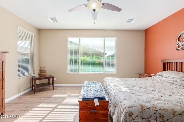 bedroom with ceiling fan and light hardwood / wood-style floors