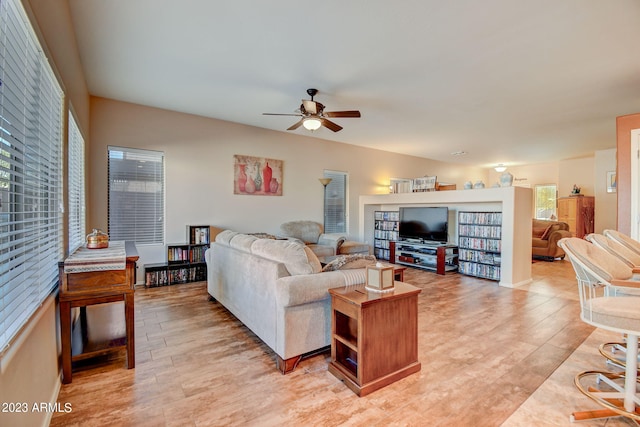 living room featuring light wood-type flooring, a wealth of natural light, and ceiling fan