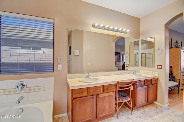 bathroom featuring tile patterned flooring, vanity, and a bathtub