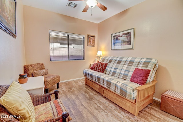 living room with ceiling fan and light hardwood / wood-style floors