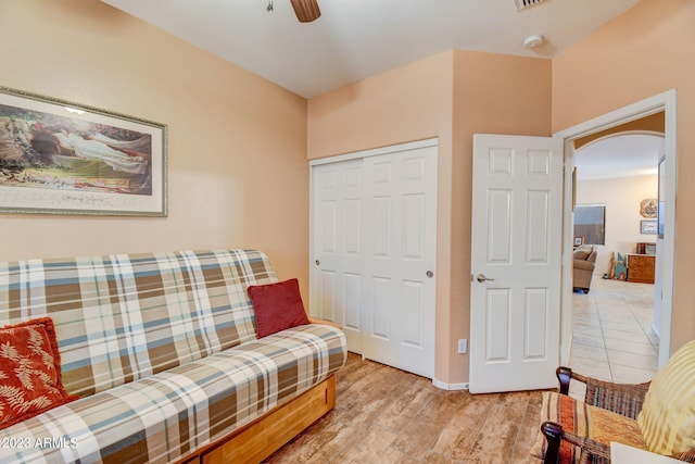 sitting room with ceiling fan and light wood-type flooring