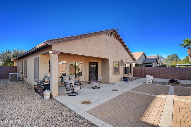 back of property with cooling unit and a patio