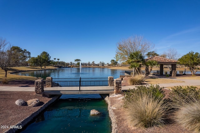 view of pool with a gazebo and a water view