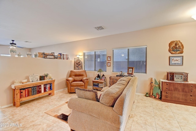 living room featuring ceiling fan, light tile patterned flooring, and a healthy amount of sunlight