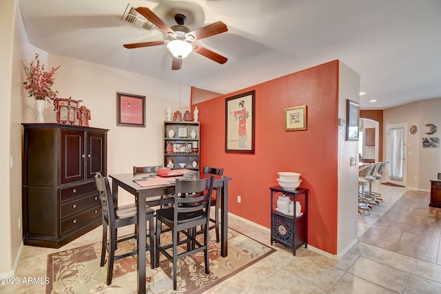 dining space with light tile patterned floors and ceiling fan