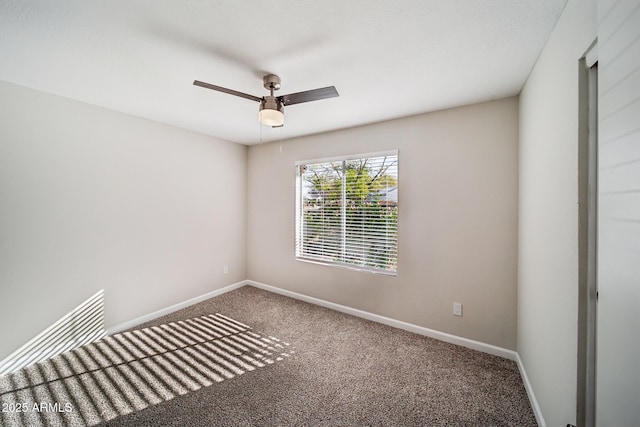 empty room featuring ceiling fan, baseboards, and carpet