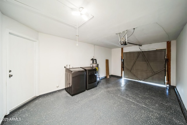 garage with washer and clothes dryer, a sink, a garage door opener, water heater, and baseboards