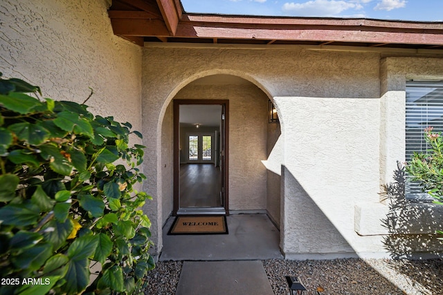 view of exterior entry featuring stucco siding