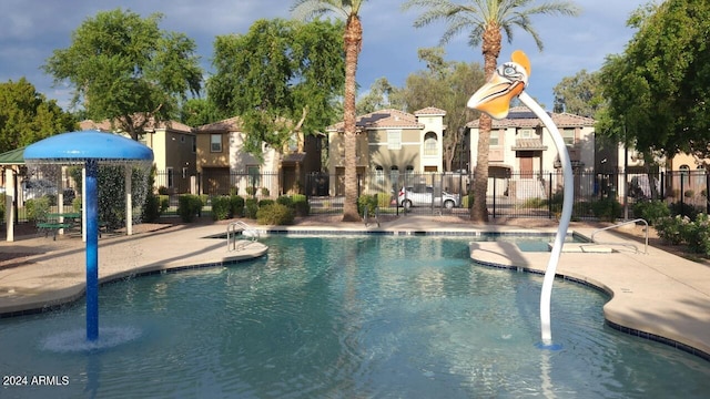 view of pool with a patio and pool water feature