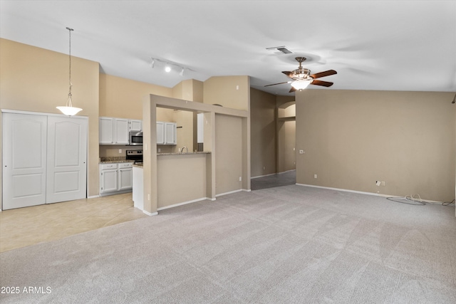 662 S Saddle St, Gilbert, AZ 85233 - unfurnished living room with light colored carpet, ceiling fan, vaulted ceiling, track lighting, and baseboards