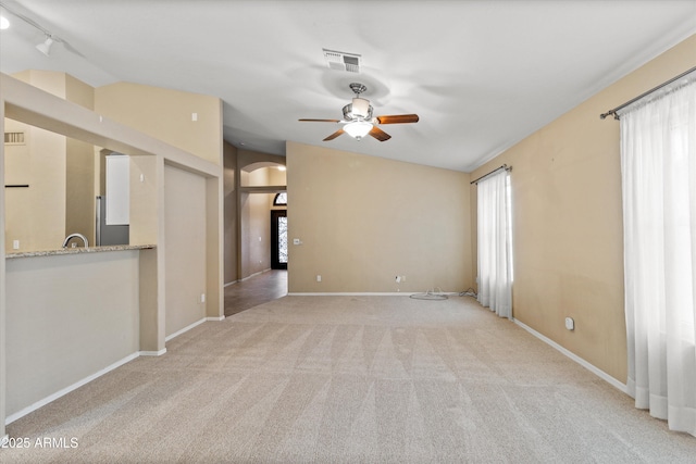 662 S Saddle St, Gilbert, AZ 85233 - empty room featuring ceiling fan, light carpet, arched walkways, vaulted ceiling, and baseboards