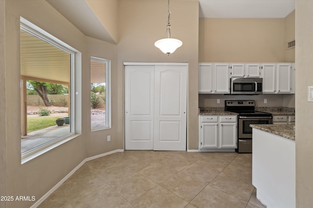 662 S Saddle St, Gilbert, AZ 85233 - kitchen featuring appliances with stainless steel finishes, a high ceiling, white cabinets, stone countertops, and light tile patterned floors