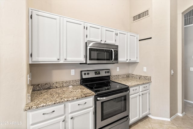 662 S Saddle St, Gilbert, AZ 85233 - kitchen with appliances with stainless steel finishes, white cabinets, light stone countertops, and baseboards