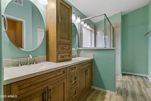 662 S Saddle St, Gilbert, AZ 85233 - full bathroom with a tile shower, wood finished floors, and double vanity