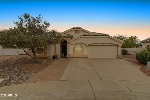 662 S Saddle St, Gilbert, AZ 85233 - mediterranean / spanish-style home with a garage, driveway, stucco siding, a tiled roof, and fence