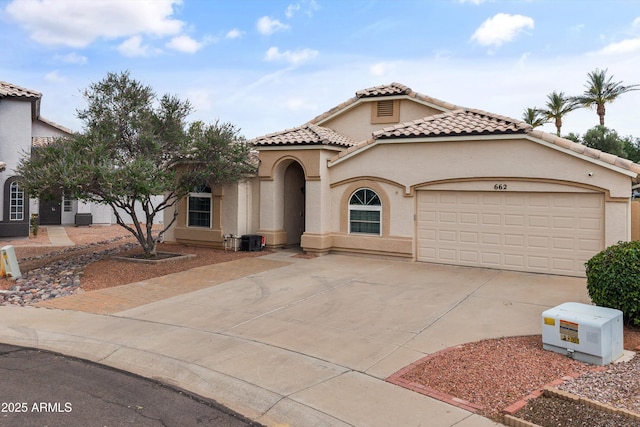662 S Saddle St, Gilbert, AZ 85233 - mediterranean / spanish-style home featuring driveway, a garage, a tiled roof, and stucco siding