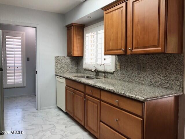 1156 E Vinedo Ln, Tempe, AZ 85284 - kitchen with dishwasher, a sink, decorative backsplash, and brown cabinetry