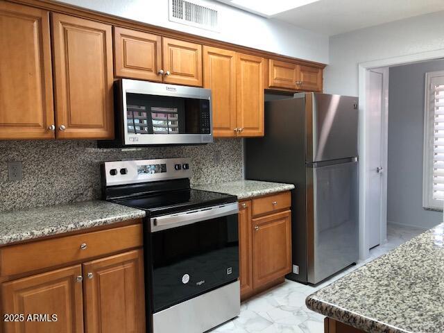 1156 E Vinedo Ln, Tempe, AZ 85284 - kitchen featuring stainless steel appliances and brown cabinetry