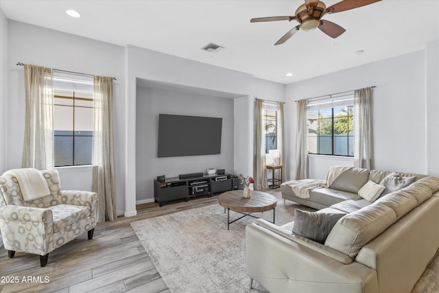 living room with ceiling fan and light wood-type flooring