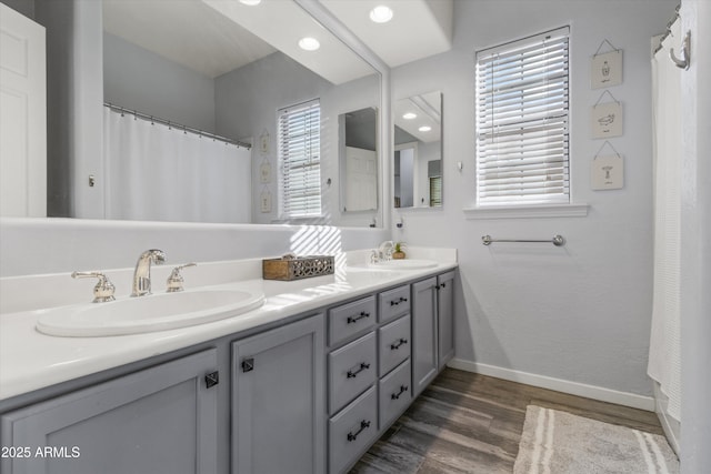 bathroom with vanity, hardwood / wood-style flooring, and a wealth of natural light