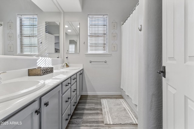 bathroom with vanity, hardwood / wood-style floors, and shower / bath combo with shower curtain