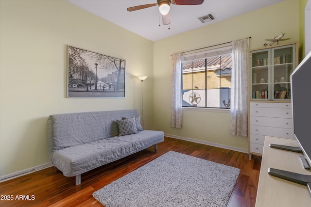 sitting room with ceiling fan and dark hardwood / wood-style floors