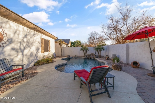 view of pool with pool water feature and a patio