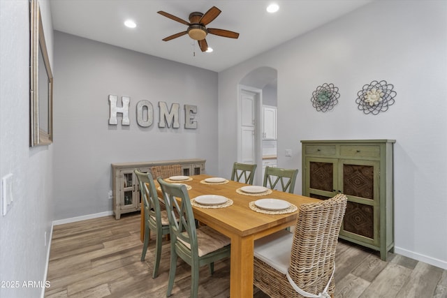 dining area with light wood-type flooring and ceiling fan