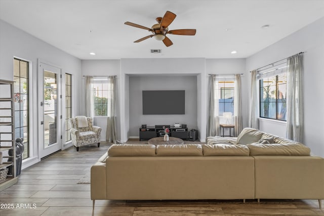 living room with ceiling fan and a wealth of natural light