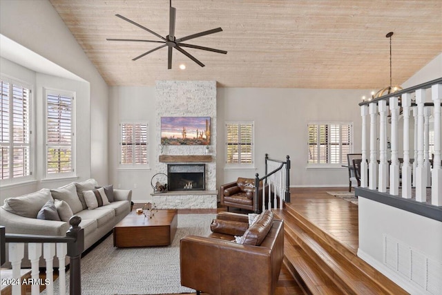 living room featuring wood-type flooring, lofted ceiling, and plenty of natural light