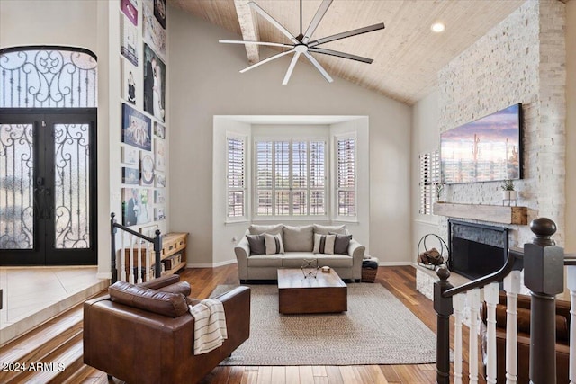 living room with french doors, a fireplace, hardwood / wood-style floors, and wooden ceiling