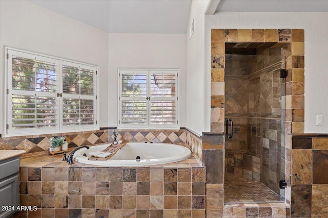 bathroom featuring vanity and separate shower and tub