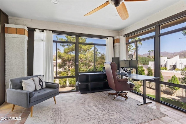 sunroom / solarium featuring ceiling fan