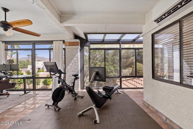 workout room with a wall unit AC and ceiling fan