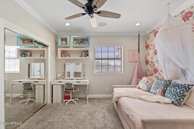 bedroom with ornamental molding, ceiling fan, light colored carpet, and a closet