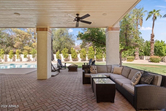 view of patio with an outdoor living space, ceiling fan, and a fenced in pool