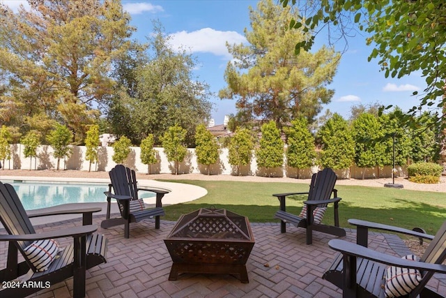 view of patio featuring a fenced in pool and a fire pit