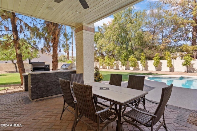 view of patio / terrace with a fenced in pool and a grill