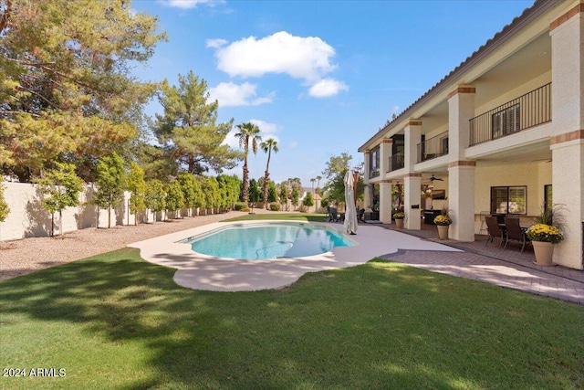 view of swimming pool with a patio, a yard, and ceiling fan