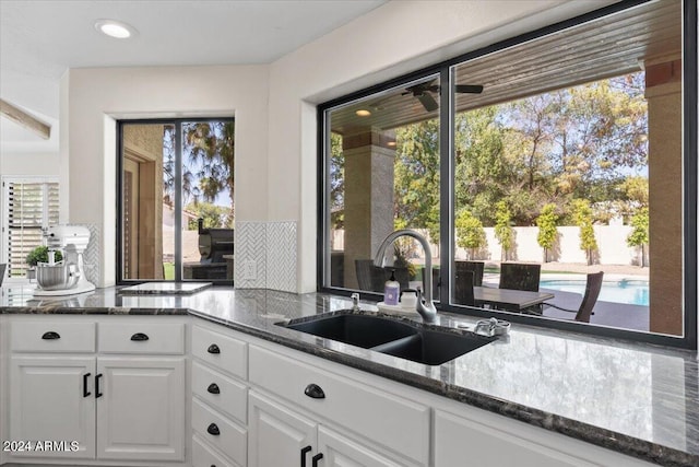 kitchen with plenty of natural light, sink, and white cabinetry