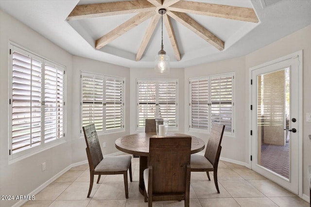 tiled dining area with lofted ceiling with beams and plenty of natural light