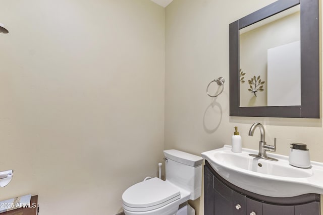 half bathroom featuring toilet and vanity