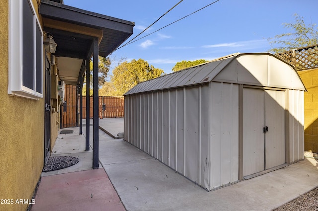 view of shed with fence