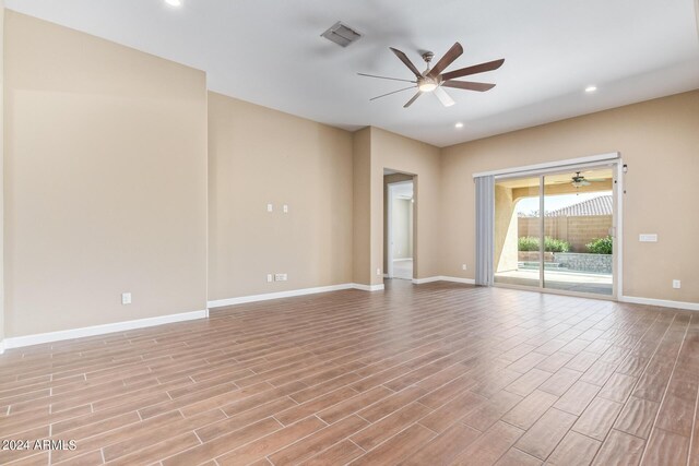 unfurnished room with ceiling fan and light hardwood / wood-style floors