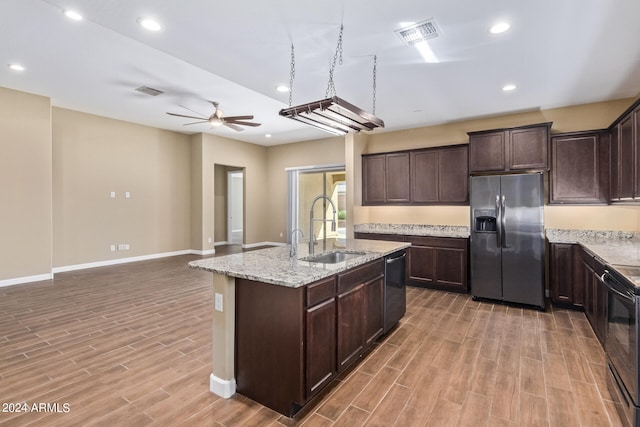 kitchen featuring ceiling fan, hardwood / wood-style flooring, appliances with stainless steel finishes, and sink