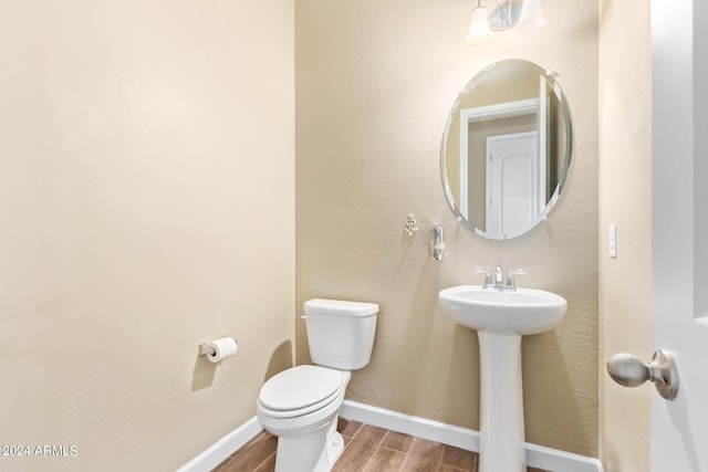 bathroom with wood-type flooring and toilet