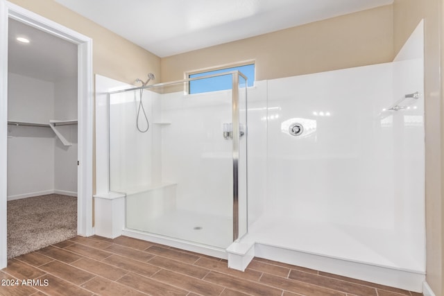 bathroom with a shower with door