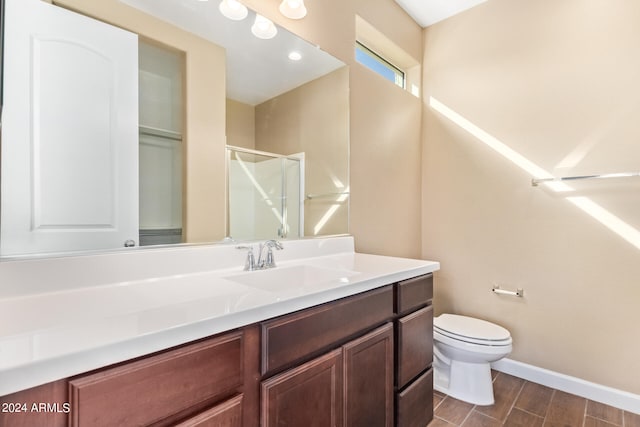 bathroom with vanity, hardwood / wood-style floors, toilet, and a shower with door