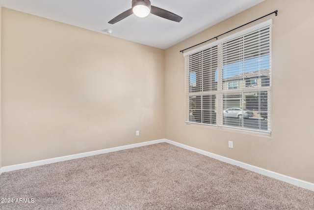 empty room featuring ceiling fan and carpet flooring